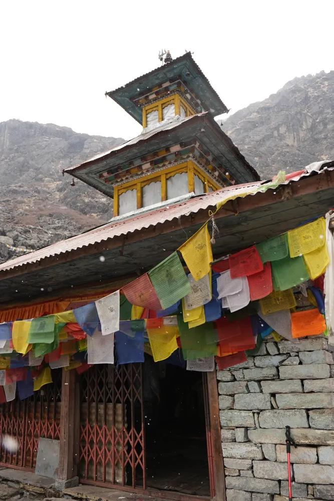 prayer flags in snowfall - panch pokhari